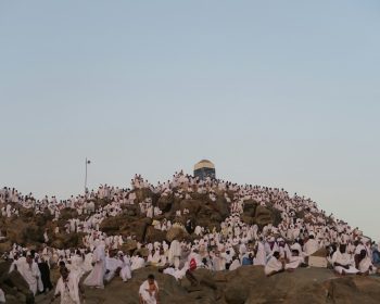 hujjaj praying on top of mount arafat during hajj